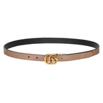 Two-toned belt with gold Gucci logo buckle on a light gray background