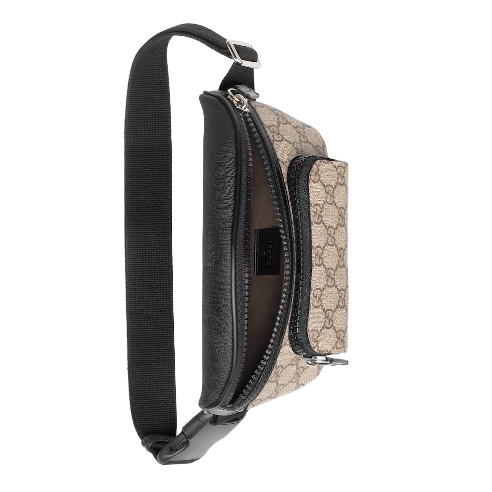 Beige and black patterned bag with a black strap on a light gray background