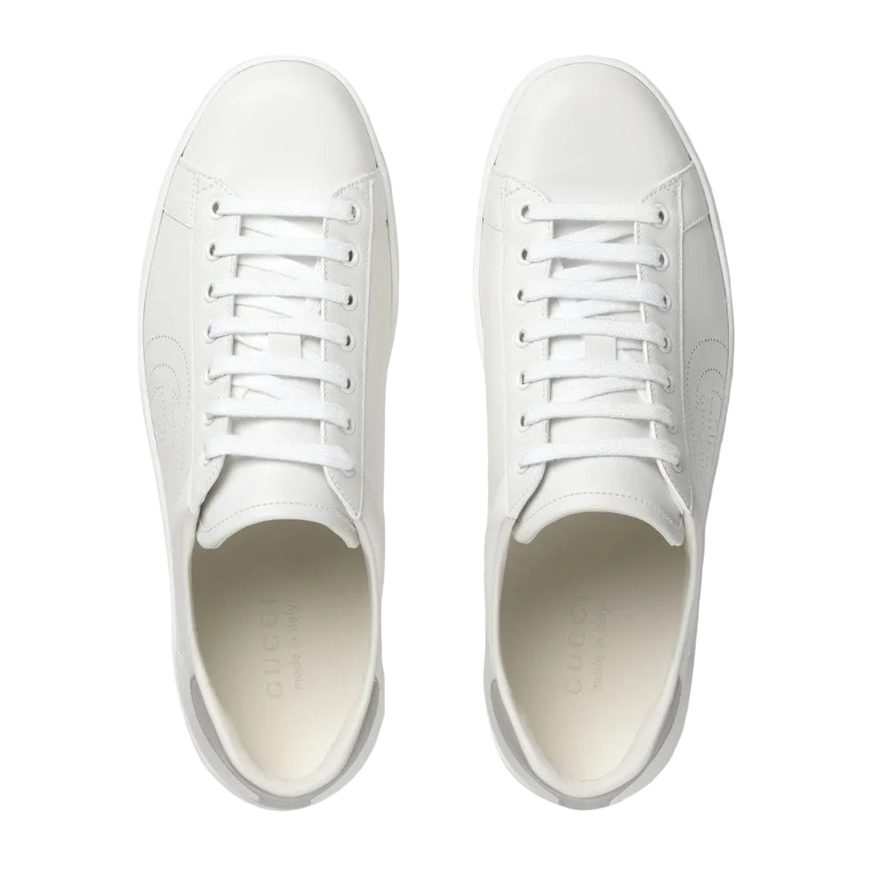 Pair of white sneakers on a light gray background