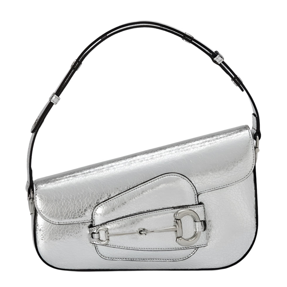 Silver Gucci horsebit handbag with a black handle on a light gray background