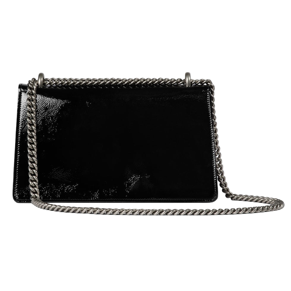 Black handbag with chain strap on a light gray background