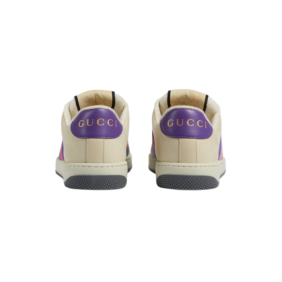 Beige Gucci sneakers with purple accents on a light gray background