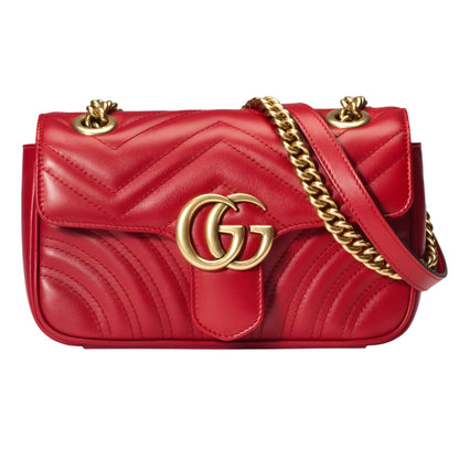 Red quilted handbag with gold chain andGG logo on a light gray background
