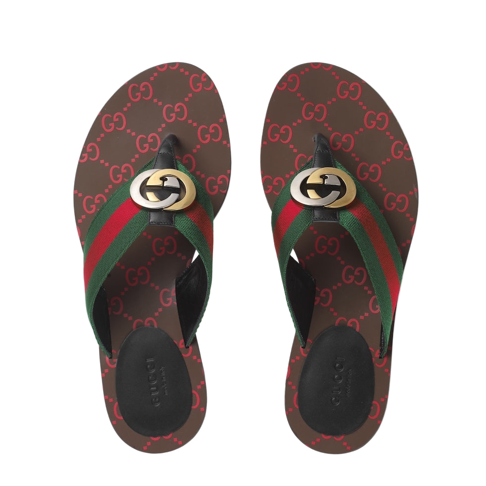 Pair of Gucci flip-flops with logo on a white background