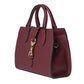 Maroon handbag with gold accents on a light gray background