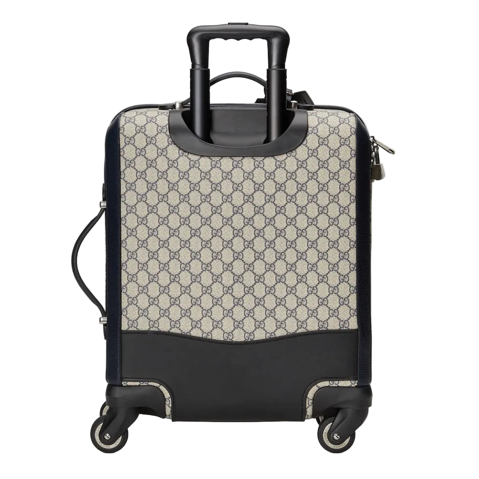 Patterned suitcase with black accents on a light gray background