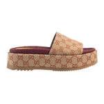 Beige and brown slide sandal with Gucci logo pattern on a light gray background