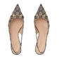 Pair of Gucci flats with patterned design and gold accents on a light gray background