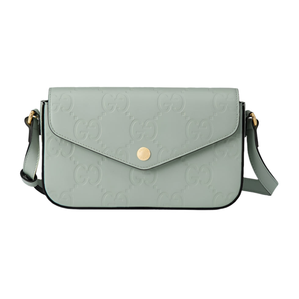 Light green handbag with Gucci logo on a light gray background