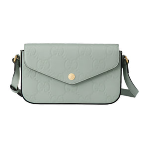 Light green handbag with Gucci logo on a light gray background