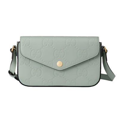 Light green handbag with Gucci logo on a light gray background