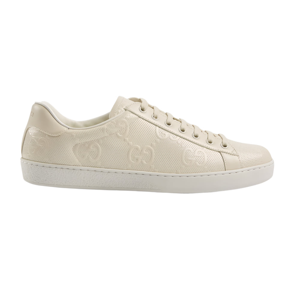 Beige sneaker with brand logo on a light gray background