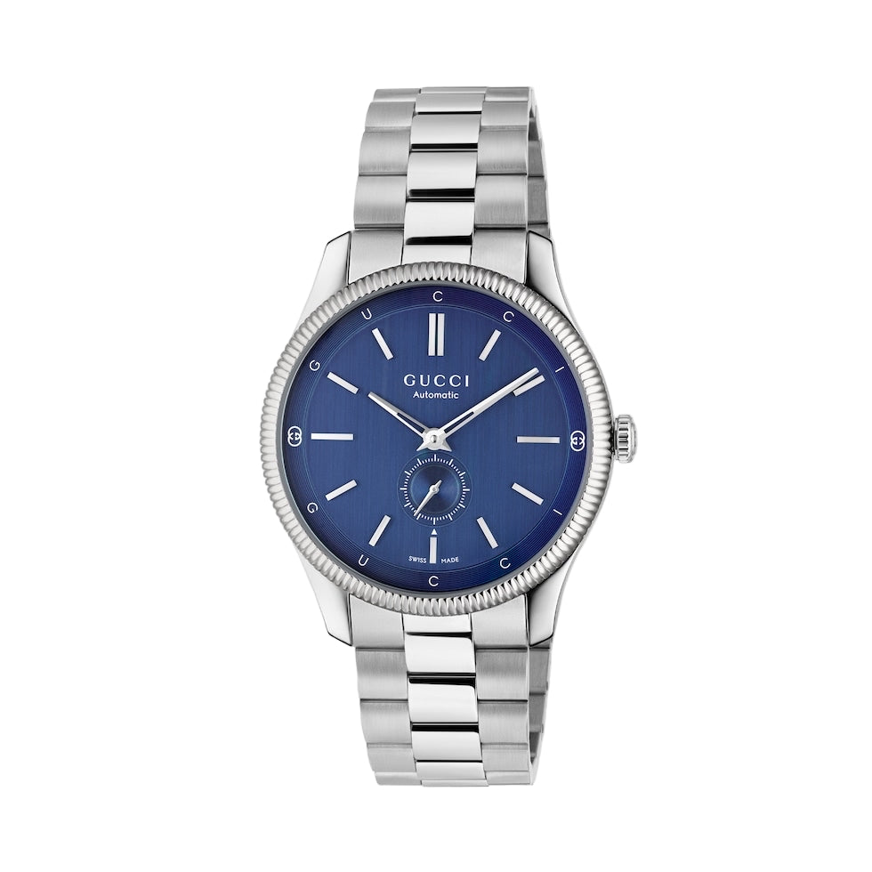 Gucci watch with blue dial and silver metal bracelet on a light gray background