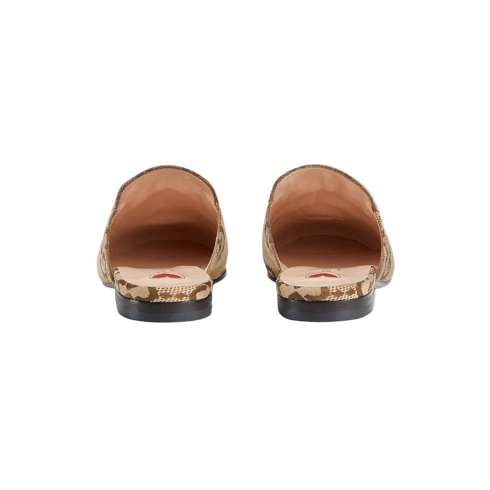 Pair of tan loafers with camouflage soles on a light gray background