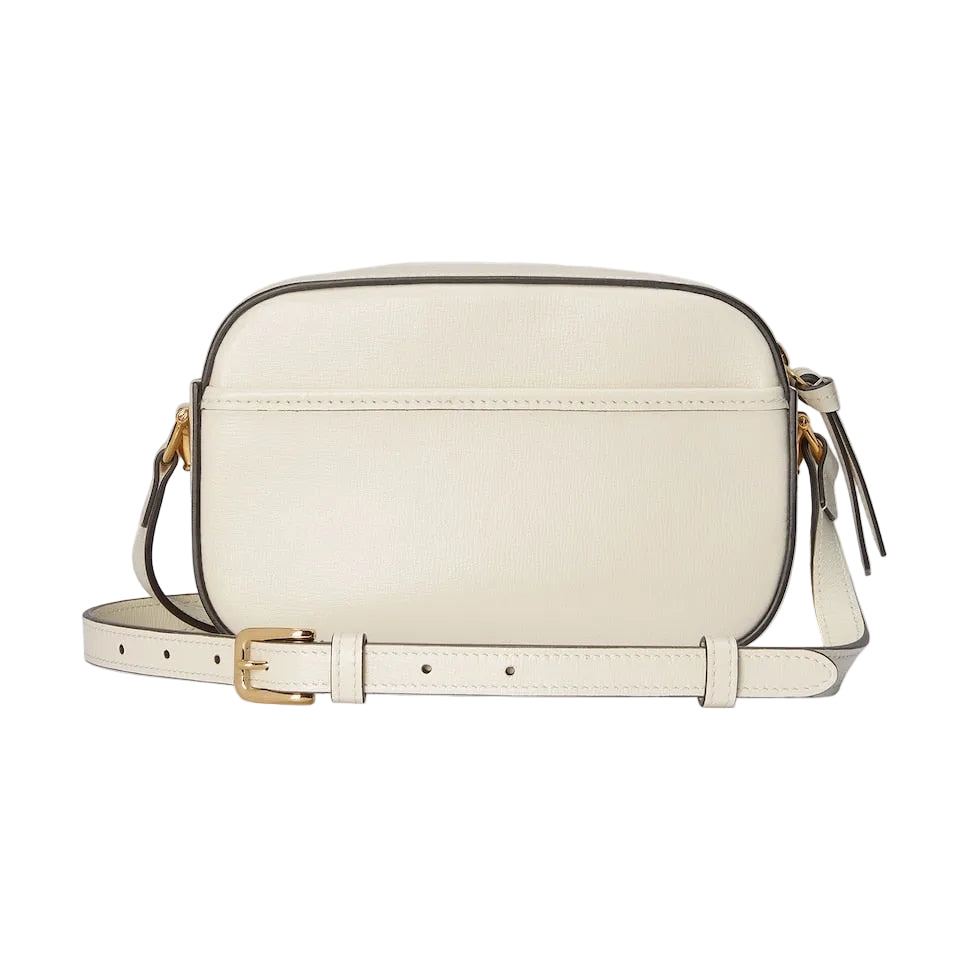 White handbag with gold accents on a light gray background