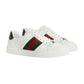 White sneakers with green and red stripes on a white background