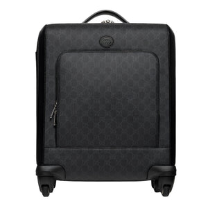 Black Gucci suitcase with a geometric pattern on a white background