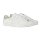 White sneakers with a brand logo on a light gray background