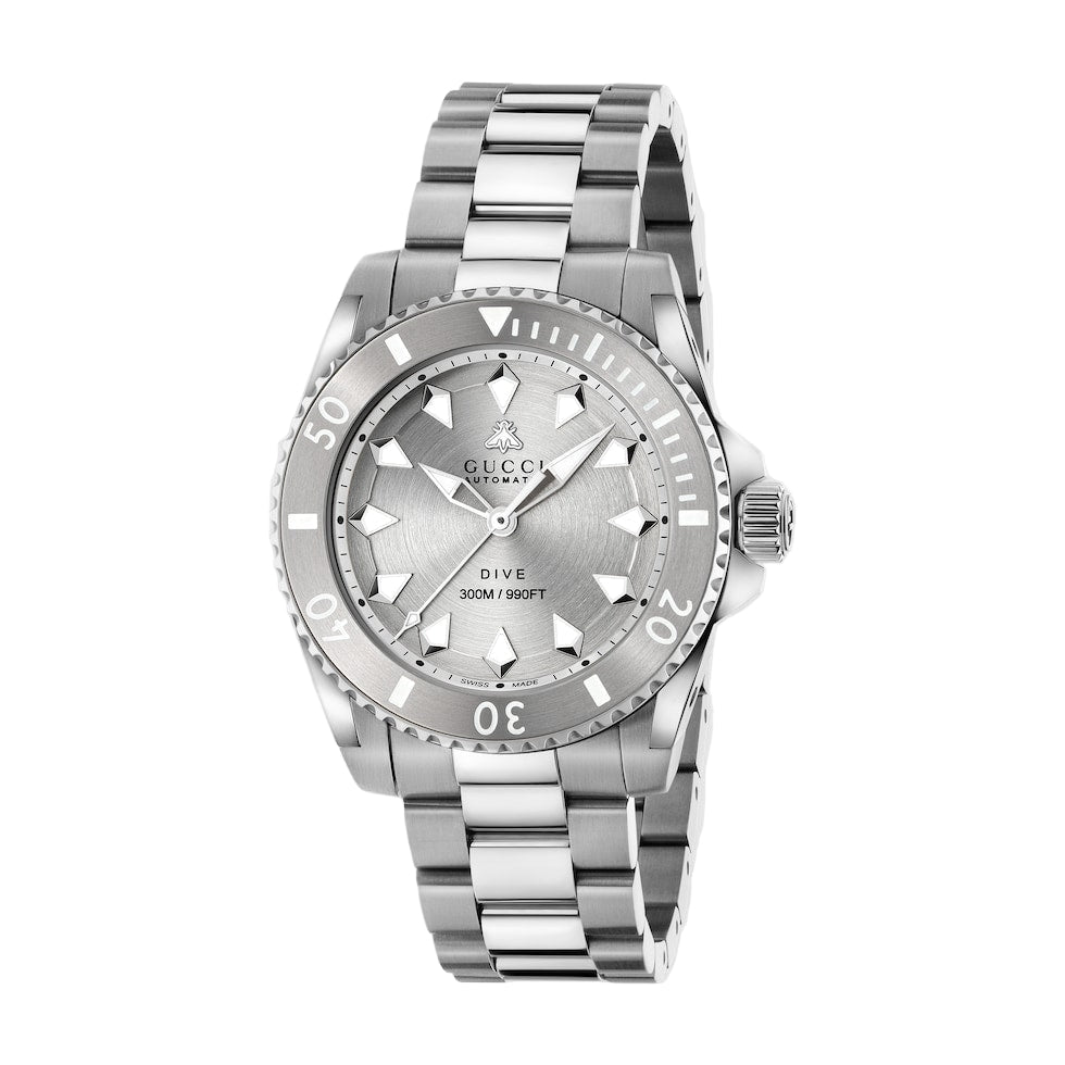 Silver Gucci watch with a detailed face on a light gray background