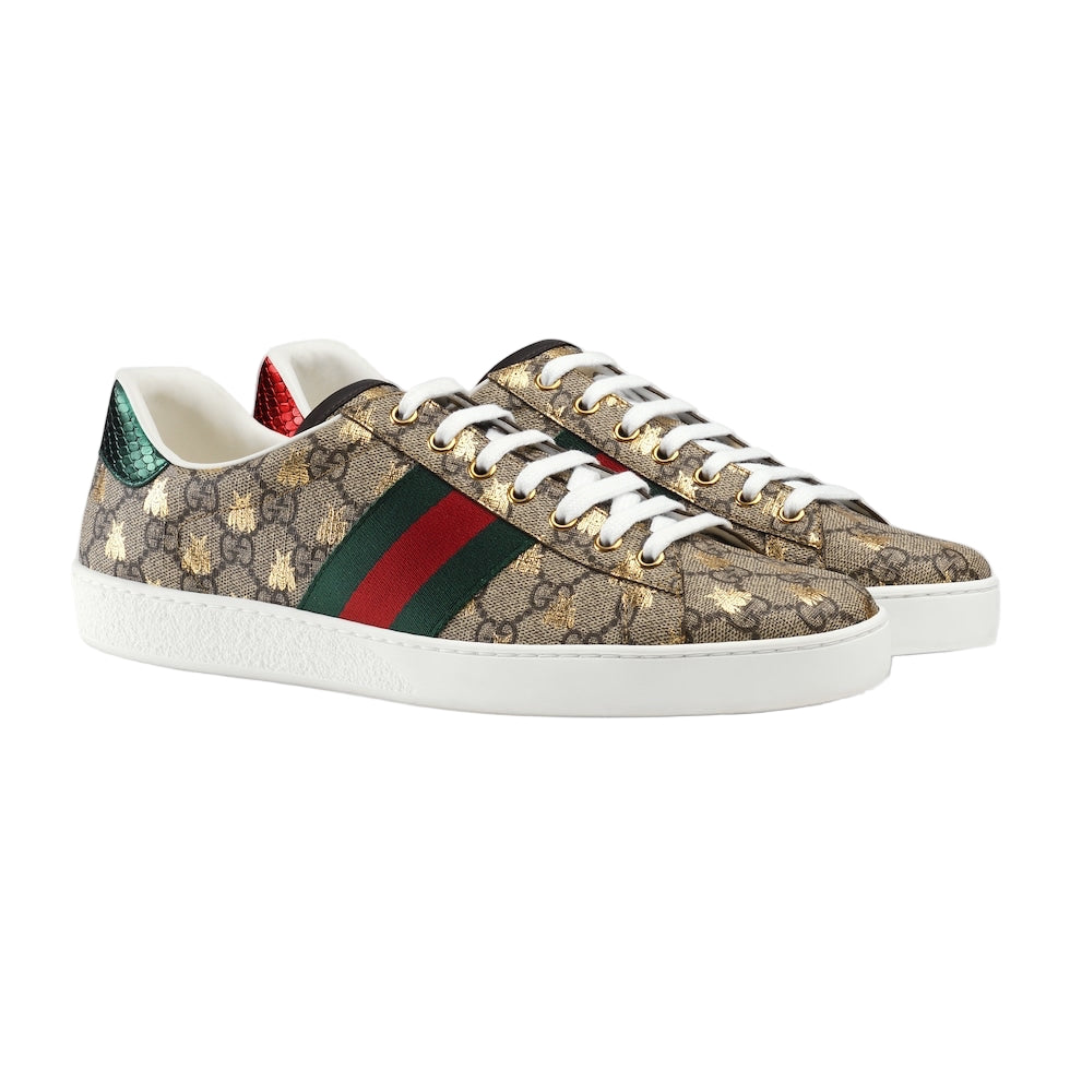 Gucci sneakers with patterned design and iconic red and green stripe on a light gray background