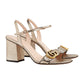 Gold glittery high-heeled sandals with a Gucci logo on a light gray background