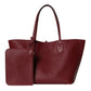 Red leather tote bag with matching wallet on a light gray background
