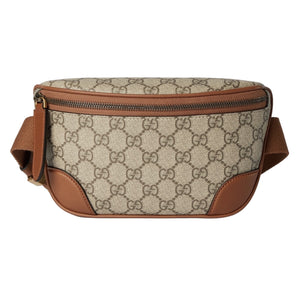 Beige and brown patterned waist bag on a light gray background