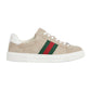 Beige Gucci sneaker with green and red stripe on a light gray background