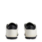 White sneakers with black soles on a light gray background