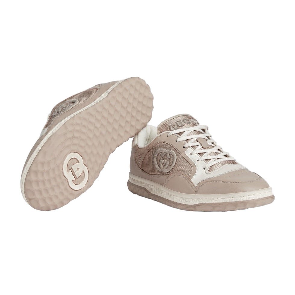 Beige sneakers with a heart logo on a light gray background