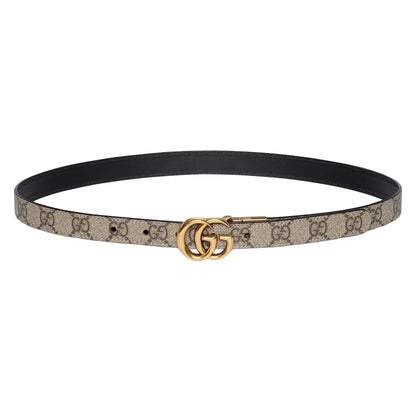 Designer belt with gold buckle on a light gray background