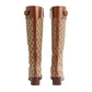 Pair of Gucci knee-high boots with brown and beige pattern on a white background