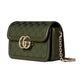 Green handbag with gold chain and logo on a light gray background
