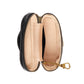 Open black leather pouch with beige interior and gold zipper on a light gray background