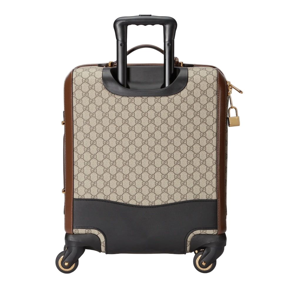 Patterned suitcase with black handle and base on a light gray background