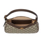 Designer handbag with brown leather accents on a light gray background