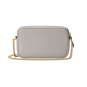 Gray handbag with a gold chain on a light gray background