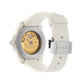 Gucci watch with white strap and gold mechanical face on a light gray background