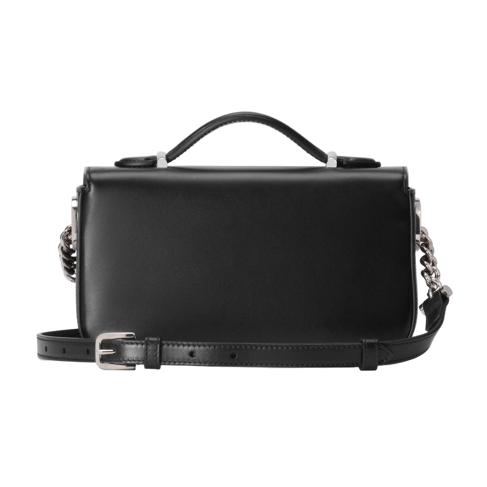 Black leather handbag with chain detail on a light gray background