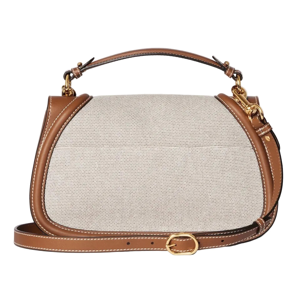 Handbag with beige canvas body and brown leather straps on a light gray background