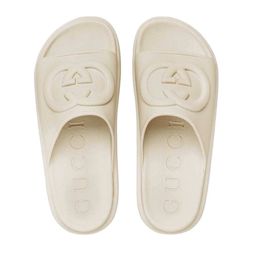 Beige Gucci slides on a white background