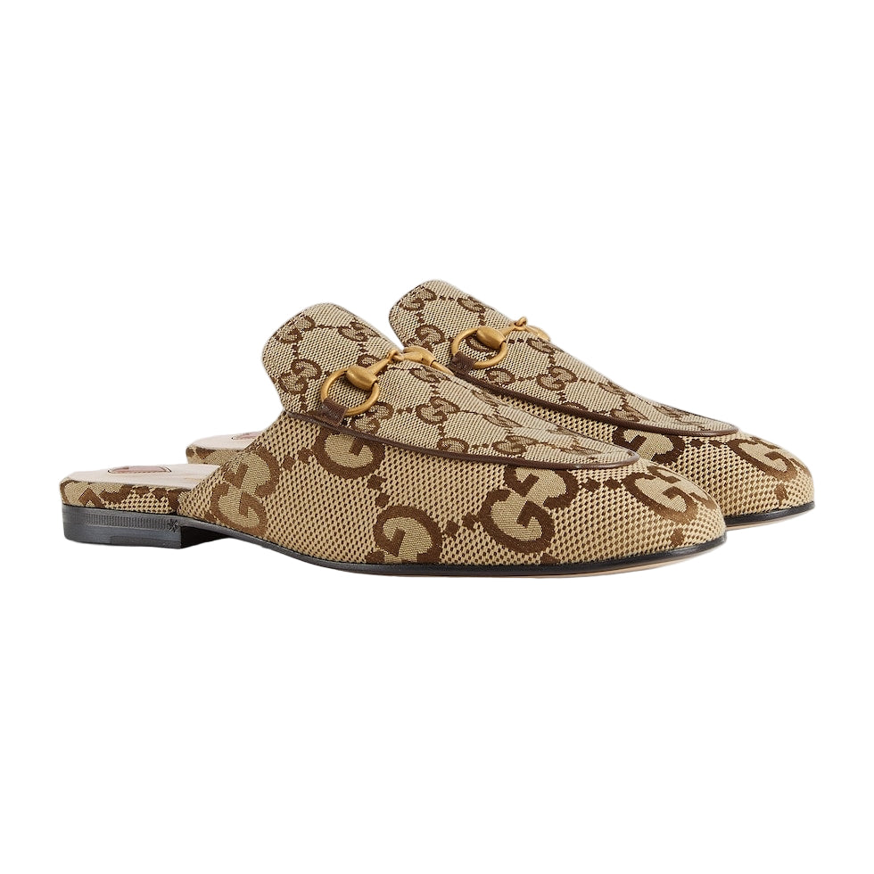 Pair of beige loafers with a gold logo on a light gray background