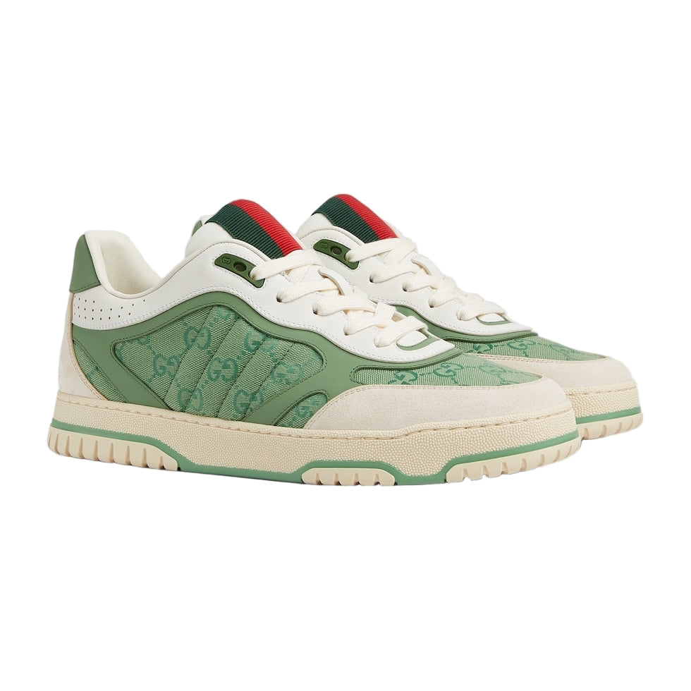 Green and white sneakers with red accents on a light gray background