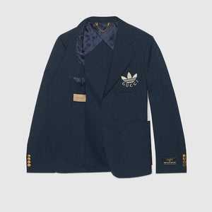 Navy blue blazer with Gucci logo on a light gray background