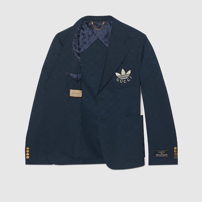 Navy blue blazer with Gucci logo on a light gray background