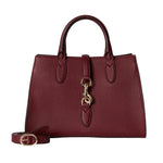 Red handbag with gold accents on a light gray background