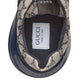 Gucci sneaker with patterned side and visible brand label on a light gray background