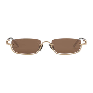 Sunglasses with gold frame and brown lenses on a light gray background