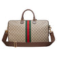 Designer handbag with GG pattern and red and green stripe on a light gray background