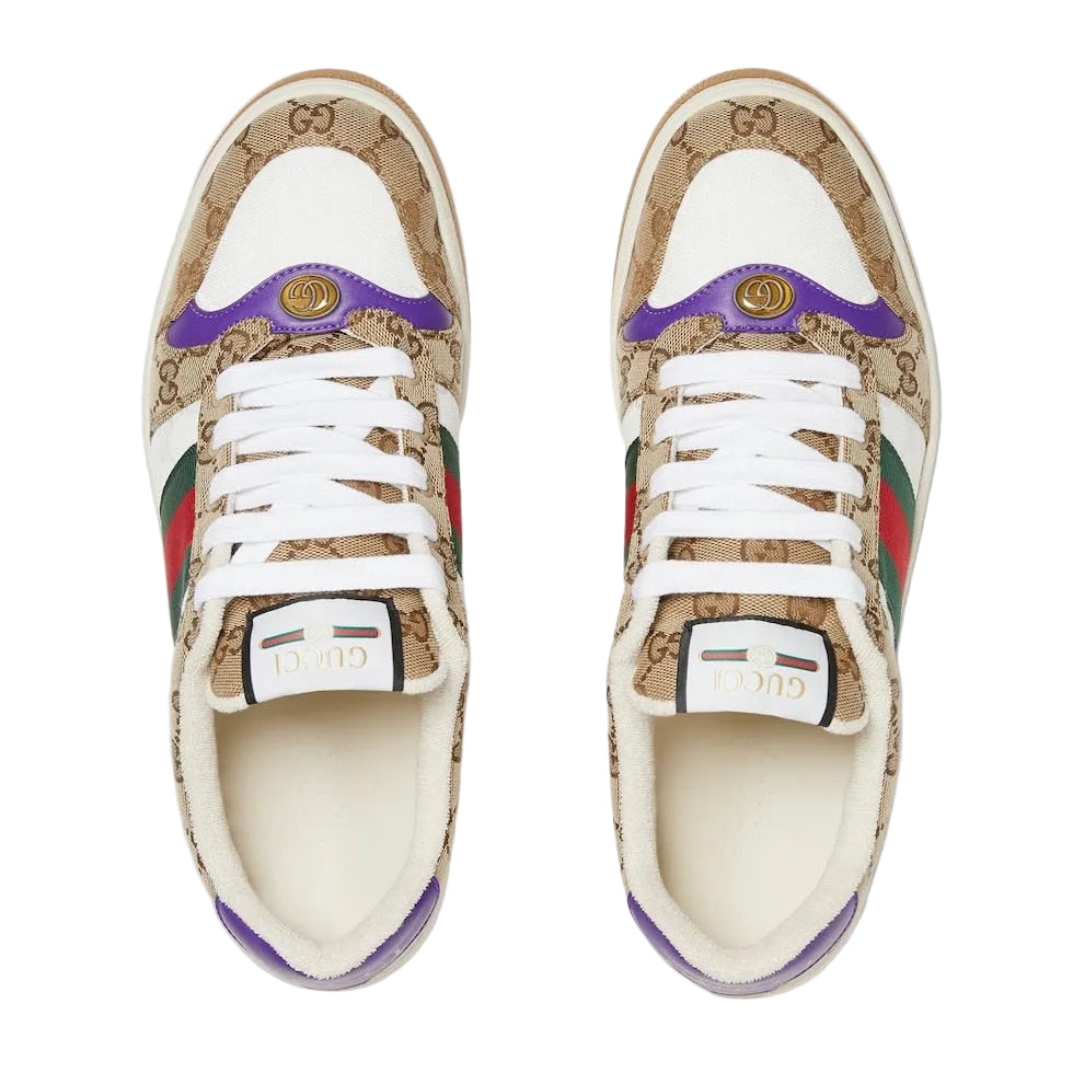 Pair of Gucci sneakers with a distinctive pattern on a light gray background